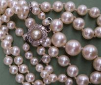 A pearl necklace with graduated beads, with a diamond set clasop together with a locket,