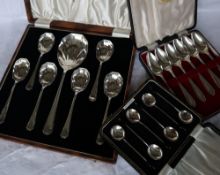 A set of six George VI silver dessert spoons and matching serving spoon, with panelled bowls,