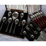 A set of six George VI silver dessert spoons and matching serving spoon, with panelled bowls,