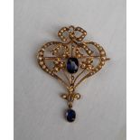 An Edwardian 9ct gold sapphire and seed pearl pendant, of heart shape with a bow to the top,