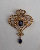 An Edwardian 9ct gold sapphire and seed pearl pendant, of heart shape with a bow to the top,