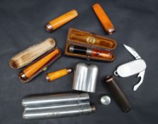 A collection of 9ct gold and amber cigar holders,