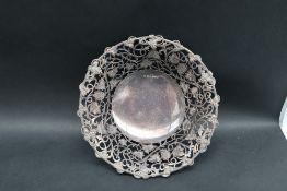 A modern silver dish, with a pierced grape and leaf border on three scrolling legs, 20cm diameter,