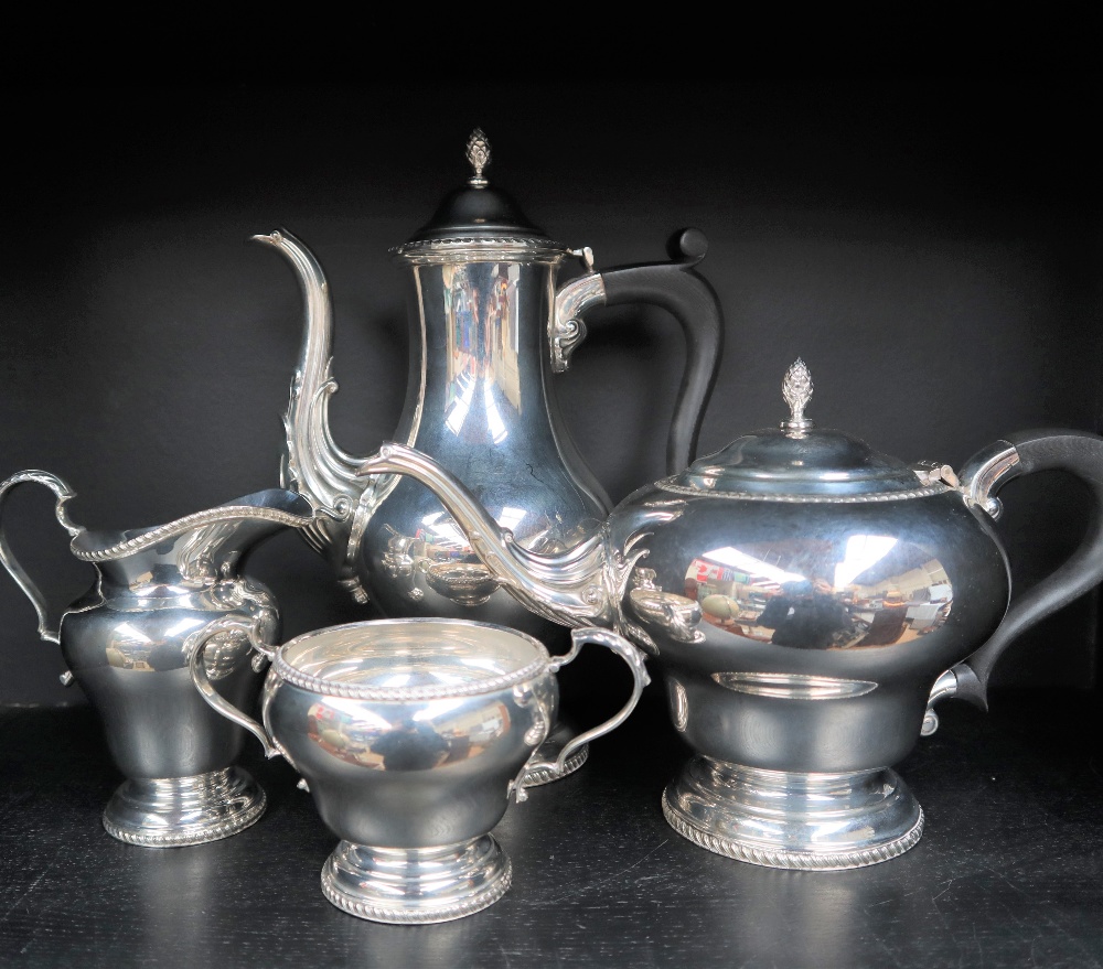 An Elizabeth II silver four piece tea set, with a baluster hot water jug, teapot,