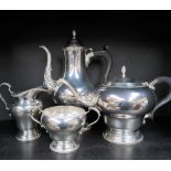 An Elizabeth II silver four piece tea set, with a baluster hot water jug, teapot,