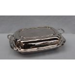 A George VI silver entree dish and cover of rectangular form, the lid with integral handles,