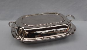 A George VI silver entree dish and cover of rectangular form, the lid with integral handles,