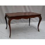 A French mahogany and gilt metal mounted coffee table with a serpentine top on cabriole legs and