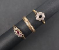 A 9ct gold wedding band size R together with a 9ct gold ruby and diamond ring and a 9ct gold