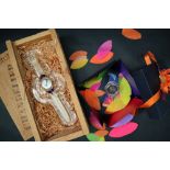 A Swatch Chandelier wristwatch, with original glass stand, wooden box and shavings,