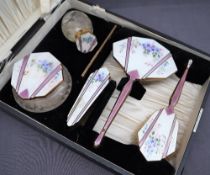 An enamel and gilt decorated five piece dressing table set,