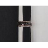 A diamond half eternity ring set with two central rows of black diamonds,