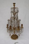 A gilt metal lustre drop candelabra, with a central candle stick,