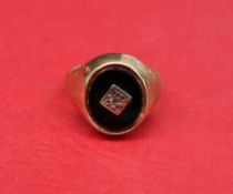 A 9ct gold signet ring set with an onyx panel, size K 1/2 approximately 5.