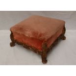 A French giltwood and gesso foot stool of square form, carved with leaves on scrolling feet,