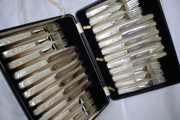 A set of twelve George V silver fruit knives and forks,