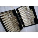 A set of twelve George V silver fruit knives and forks,