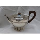 A George V silver teapot, with a ribbed body on a spreading foot, Birmingham,