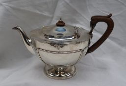 A George V silver teapot, with a ribbed body on a spreading foot, Birmingham,