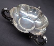 An Edward VII silver lobed dish with three scrolling handles and pad feet, Birmingham, 1910,