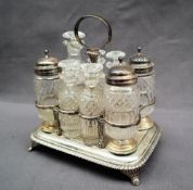 A late George III silver cruet with eight bottles, some with silver tops,