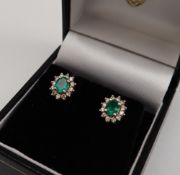 A pair of emerald and diamond earrings,