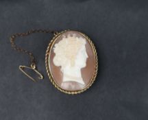 A 9ct gold shell cameo brooch, depicting a maiden with a pearl necklace in profile, 35mm high,