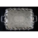 An Edward VII silver twin handled tray, with a d shaped edge cast with scrolls and leaves,