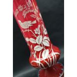 A Victorian opaque glass overlay decorated vase of tapering form on a spreading foot,