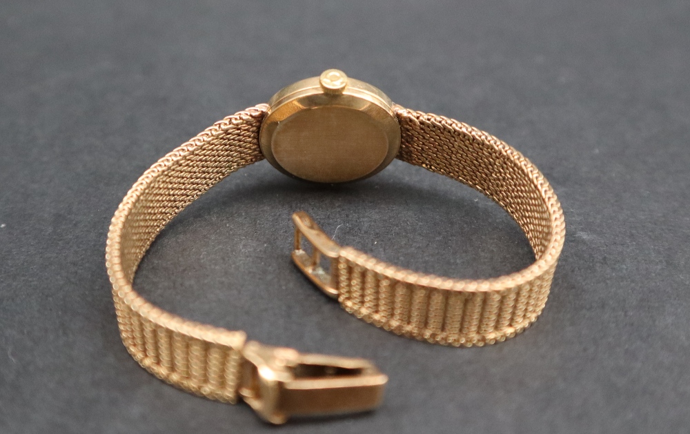 A lady's 9ct gold Omega wristwatch, the gilt dial with batons on an integral 9ct gold strap, - Image 5 of 6