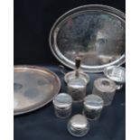 A collection of silver topped and cut glass dressing table pots together with electroplated platers,