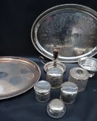 A collection of silver topped and cut glass dressing table pots together with electroplated platers,