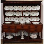 A 19th century Copenhagen porcelain part dinner set painted with garden flowers to a basket weave