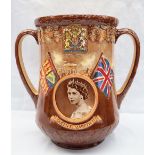 A Royal Doulton twin handled loving cup in commemoration of the Coronation of Queen Elizabeth II at