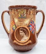 A Royal Doulton twin handled loving cup in commemoration of the Coronation of Queen Elizabeth II at