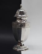 A George VI silver sugar caster of tapering octagonal form, with a domed cover and pointed finial,
