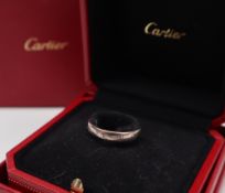 A Cartier 18ct white gold wedding band decorated with the Cartier trade mark, size Q,