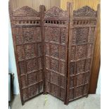A carved hardwood three fold screen, with pierced decoration,