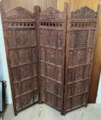 A carved hardwood three fold screen, with pierced decoration,
