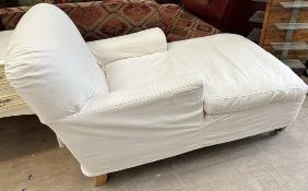 A modern upholstered day bed on tapering legs