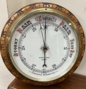 An oak framed aneroid barometer, of circular form,