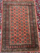 A Mossoul woven rug, with a red ground and multiple guls and guard stripes,