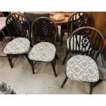 A set of four wheel and stick back dining chairs on turned legs