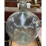 A large green glass carboy,