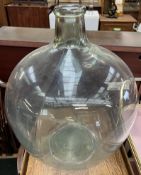 A large green glass carboy,