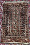A Persian rug with a red ground, a central panel of seven guls and multiple guard stripes,