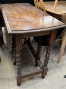 A 20th century oak gateleg dining table with barley twist legs