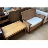A caned two seater settee with a pad seat together with a coffee table