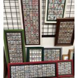 A collection of framed cigarette cards, including Players,
