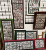 A collection of framed cigarette cards, including Players,